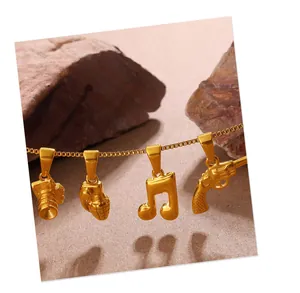 Detail of vintage gold charms featuring camera, grenade, music note, and pistol on box chain