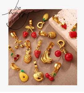 Detailed view of assorted colorful enamel fruit charms with gold metal finish and crystals