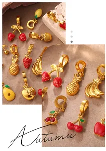 Macro detail of gold plated fruit charms with vibrant enamel on rustic stone background