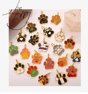 Macro shot of colorful paw print charms with Dog Mom engraving for DIY jewelry