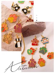 Detailed macro view of colorful enamel dog paw charms with gold plating and heart patterns