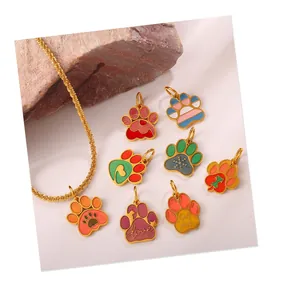 Detailed macro view of colorful enamel dog paw pendants on textured natural rock background