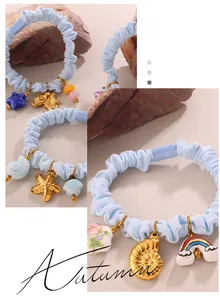 Close-up of blue scrunchies with starfish and seashell charms for hair styling