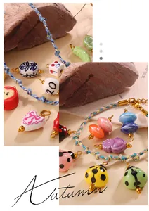 Detailed macro shot of ceramic ladybug and heart pendants with braided cords