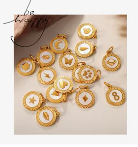 Close-up of golden charms with mother-of-pearl inlay featuring stars, moon and butterfly