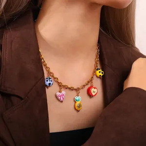 Gold charm necklace with colorful enamel ladybug, heart, and fruit pendants for women