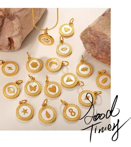 Detailed view of gold plated circular charms with diverse nature icons on textured rock