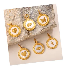 Set of 6 gold embossed pendants with butterfly and heart icons on stone background