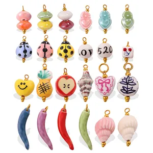 Mix of colorful ceramic charms including ladybug and seashell shapes with gold rings