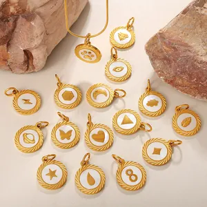 Set of 16 gold minimalist round shell pendants with shell inlay on organic stone display