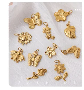 Detailed close-up of gold stainless steel vintage insect and flower jewelry pendants