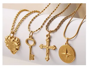 Detail of gold stainless steel necklaces with heart, key, cross and compass pendants