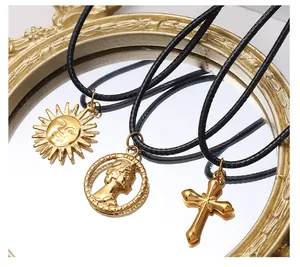Detailed close-up of golden sun, coin, and cross charms on vintage mirror surface