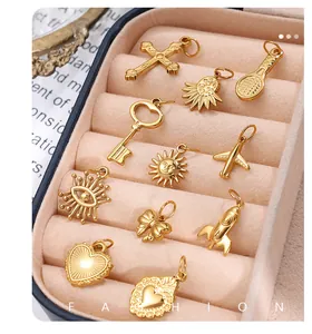 Detailed collection of 11 gold DIY pendants with sun and heart shapes in a velvet tray