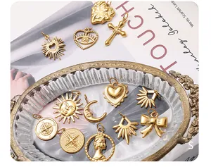 Detailed close-up of mixed gold stainless steel charms including sun and moon motifs