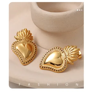 Close-up of golden sacred heart earrings with flame details and elegant hollow craftsmanship