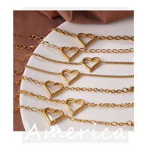 Macro shot of various 18k gold plated stainless steel hollow heart bracelets on white tray