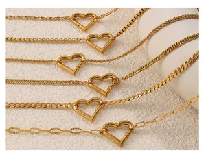 Close-up of six gold-plated chain styles featuring heart-shaped toggle clasps on white base