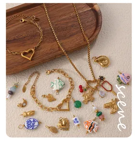 Detailed flat lay of 18k gold plated bracelets with heart clasps and diverse DIY charms