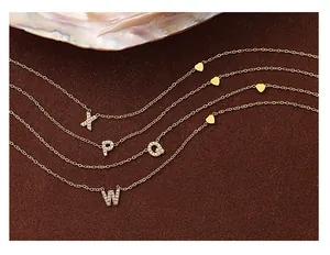 Close-up of 18K gold plated heart necklaces with sparkling crystal alphabet pendants