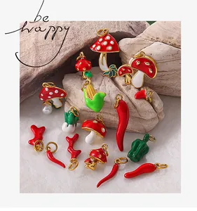 Macro shot of colorful enamel vegetable charms like mushroom and pepper on stone