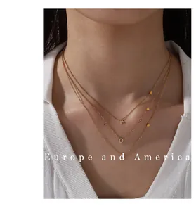 Close-up of triple-layered 18K gold-plated heart necklace with cubic zirconia letter A