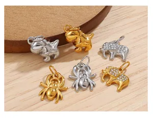 Detailed view of silver and gold animal pendants with crystal elephant and dinosaur motifs