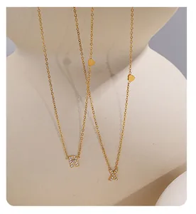 Close-up of 18K gold plated heart necklaces with crystal-encrusted letters R and X