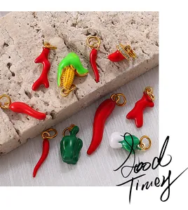 Detailed close-up of colorful enamel vegetable charms with golden loops for DIY jewelry