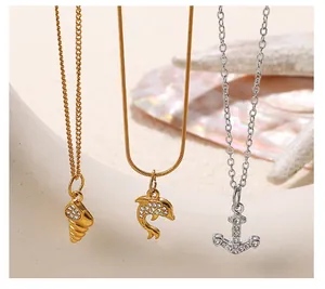 Macro shot of seashell, dolphin and anchor necklaces with crystal pave embellishments