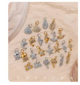 Detailed view of nautical jewelry charms with sparkling zircons in gold and silver finish
