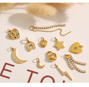 Close-up of diverse 18K gold plated charms including heart, star and moon shapes