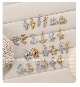 Detailed flat lay of ocean-themed charms with sparkling rhinestones in gold and silver