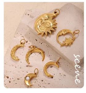 Macro shot of 18K gold plated celestial pendants featuring moon and sun motifs on stone