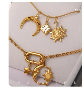 Close-up of 18K gold plated celestial pendants featuring sun, moon and star designs