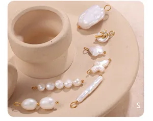 Detailed set of Baroque freshwater pearls with gold plated floral and cross pendants