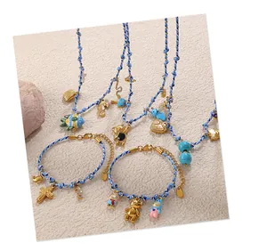 Detail of handmade woven rope necklaces and bracelets with colorful sea animal pendants