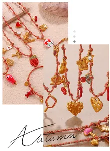 Close-up of woven rope necklaces featuring gold heart, strawberry, and star charms