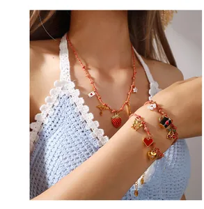 Detailed view of handmade red braided necklace and bracelets with cute novelty pendants