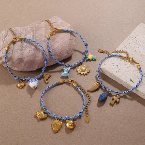 Navy blue woven bracelets with gold marine animal pendants and ceramic heart charm