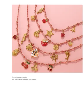 Detailed macro view of vibrant enamel charms and woven ropes with golden hardware details