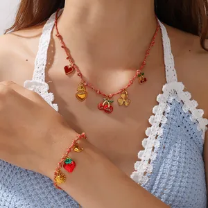 Handmade red braided cord necklace and bracelet set with cherry and heart pendants