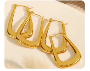 Macro shot of 18k gold plated stainless steel U-shape hoop earrings with mirror finish