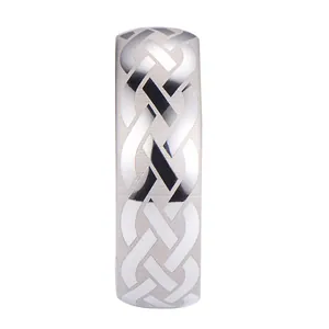 Brushed tungsten steel ring with black laser-etched Celtic knot pattern on white background