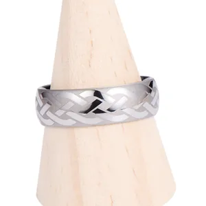 Mens tungsten ring with silver Celtic knot laser pattern on a wooden stand