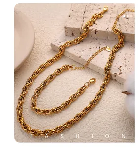 Close-up of golden stainless steel wheat chain necklace and bracelet set with lobster clasp