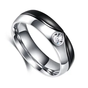 Detail of two-tone stainless steel ring with wave design and centered zircon stone