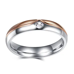 Polished two-tone stainless steel ring featuring a single central inlaid round zircon
