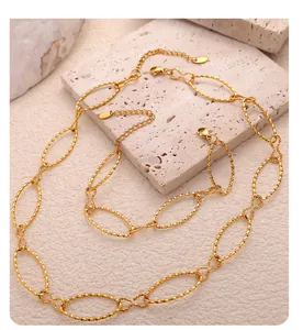 Detail of gold Cuban chain links with twisted texture, lobster clasp and extension