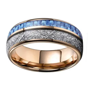 Close-up of rose gold tungsten ring featuring blue carbon fiber and meteorite inlay textures
